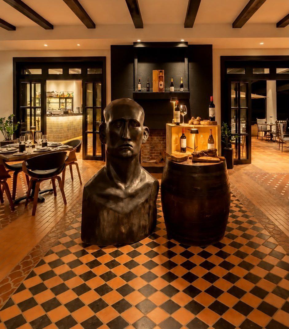 The hotel restaurant with checkered floor and bronze sculpture