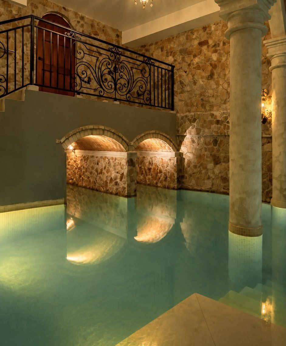 The warm-lit indoor pool at Elysium Spa